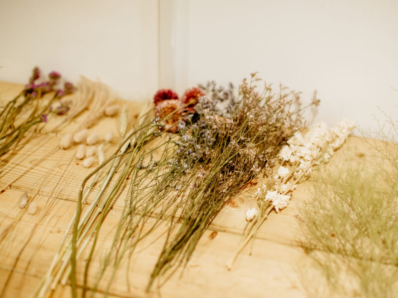 Dried flowers on a table ready to be used in a floristry class.